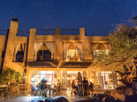 Die Terrasse der Feynan Ecolodge, unserer nachhaltigen und mit Solarenergie betriebenen Unterkunft in Jordanien, nachts unter dem Sternenhimmel.