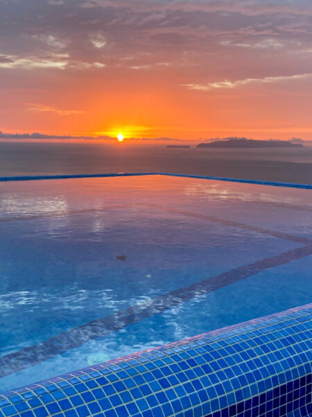 Die Sonne geht über dem Swimming Pool der Quinta dos Artistas auf Madeira, der Unterkunft über die Überschreitung der Insel, unter.